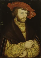 Portret van een jonge man met een baard en een rode baret