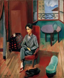 Jean Cocteau zittend in zijn atelier