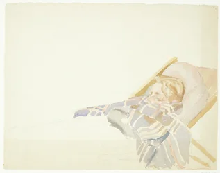 Jonge man gewikkeld in een plaid, liggend in een ligstoel