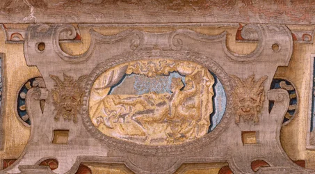 Vlaamse wandtapijt. Serie Vertumnus en Pomona. Vertumnus getransformeerd in een boer. Centrale deel van de onderste rand zien we een episode over de liefdes van Jupiter: Danaë. Tweede wandtapijt in de serie. Model Kring van Pieter Coecke van Aelst. Fabrika