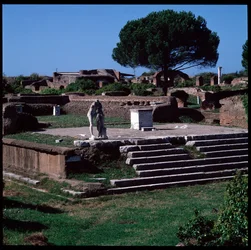 Romeinse kunst: uitzicht op de ruïnes van de tempel van Hercules en standbeeld van Gaius Cartilius Popplicola, burger van Ostia