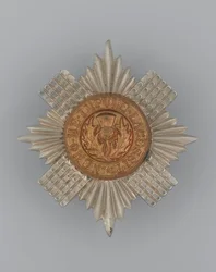 Mutsplaat, ca. 1896-1920 (metaal)