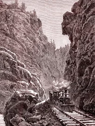 Een trein die de Colorado-bergen doorkruist. V.S.A. in 1886 (gravure)