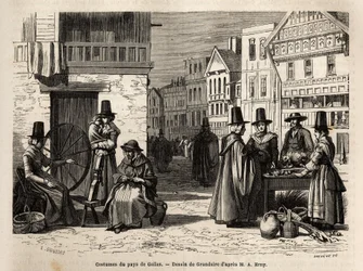 Een straat in Wales, met lokale bewoners gekleed in traditionele kostuums, en dagelijkse activiteiten: een gezin en vrouwen die wol spinnen met wielen. Gravure ter illustratie van een reis naar Wales, in 1862, door Alfred Erny, in 