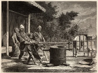 Drie boeren bedienen de rijstmolen