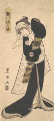 De acteur Segawa Kikunojo III als vrouw in zwart gewaad met een strohoed, 1798