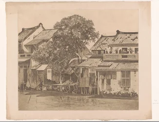 Gezicht op huizen aan een rivier in Batavia